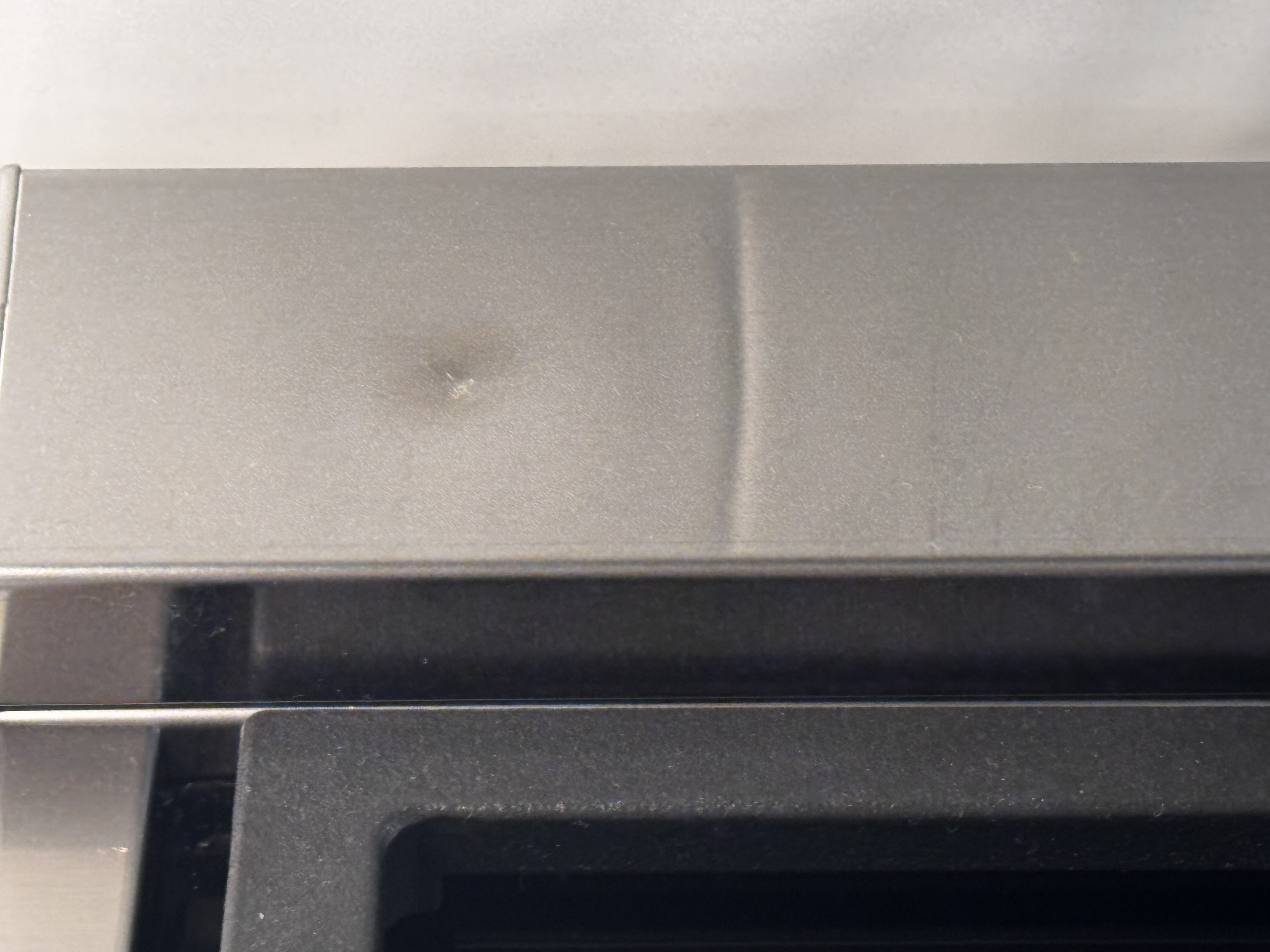 Trim piece sitting on top at the back of the stove